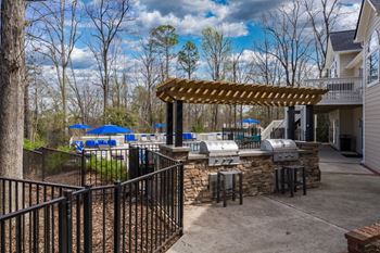Outdoor gas grills by the community pool.